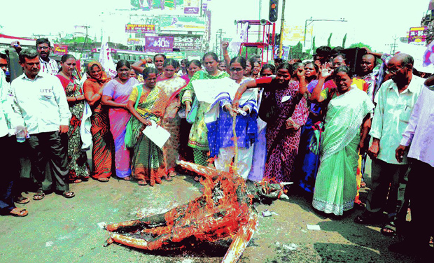 Protesters burn an effigy of film maker Ram Gopal Varma after seeing the poster at Jagadamba junction in Visakhapatnam. Protesters burn an effigy of film maker Ram Gopal Varma after seeing the poster at Jagadamba junction in Visakhapatnam.